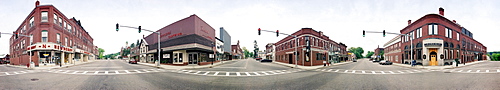 A 360 degree view from the middle of a four corner intersection in Farmington, Maine. This picture was taken with a panoramic camera that rotates as it exposes the film.