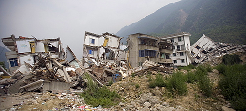 A view of collapsed buildings in Beichuan Town, which was severely damaged by a powerful 7.9 earthquake. The Chinese government raised the death toll to 21,500 but has said fatalities could rise above 50,000. Tens of thousands could still be buried in collapsed buildings in Sichuan province, where the quake was centered.