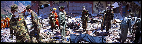 Army and rescue workers recover a body May 19 in Beichuan, China. The death toll in China's worst earthquake in 30 years could top 80, 000 according to the government.