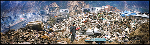 A survivor stands amid ruins in May 17 in Beichuan, China. The death toll in China's worst earthquake in 30 years could top 80, 000 according to the government.