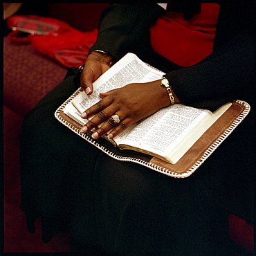 A woman rests her hand on a bible while listeing to a sermon about Covenant Marriage at Full Council Christian Fellowship in North Little Rock, Arkansas, on the sunday before Valentine's Day.