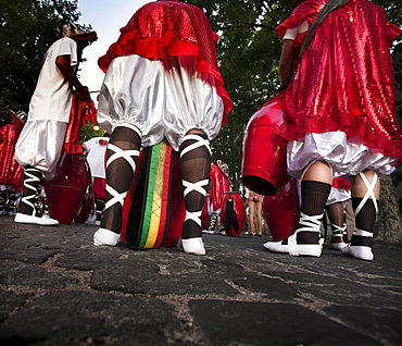 Detail of the legs of a group of men getting ready to play at the "desfile de llamadas" during the carnival celebrations in Colonia del Sacramento, Uruguay.