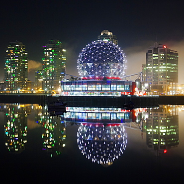 The Telus World of Science (Science World) is reflected in False Creek, Vancouver, BC.