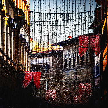 Hanging Christmas decorations and lights over street in Florence, Tuscany, Italy