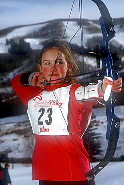 A Young participant in the relatively new sport of Ski Archery, a sport similar to biatholon but with archery instead of rifles, takes aim on a course in Park City, Utah