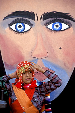 Boy and mural before the procession of the Parachicos in Chiapa de Corzo, Chiapas state, Mexico.