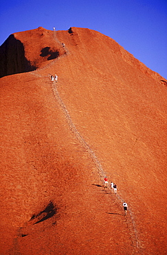 Hikers make their way up Uluru or Mt. Ayers in the Australian Outback. Located in the centre of Australia, Uluru (Ayers Rock) is the world's biggest monolith. It's 3.6 kilometres long, 2 kilometres wide and has a 9.4 kilometre circumference. Made of arkosic sandstone, Uluru changes colour in different lights, particularly at sunrise and sunse.