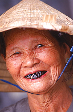 An old lady smiles for a photo in the Purple Forbidden City, Hue.