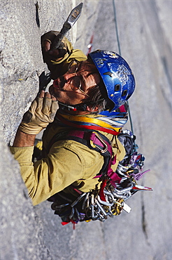 Tom McMillan blowing out a seam to place protection while making an ascent.