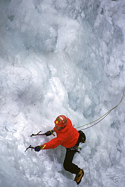 A ice climber lead climbs in Ouray, Colorado.