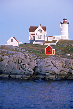 close shot of nubble lighthouse at dusk with christmas lights