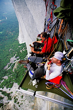 Bob Porter and Martin Avidan rest and eat dinner on a portaledge while rock climbing, aid climbing, big wall climbing up the Zodiac 5.13+ on El Capitan in Yosemite National Park, California. The team spent three days and two nights on the big wall.