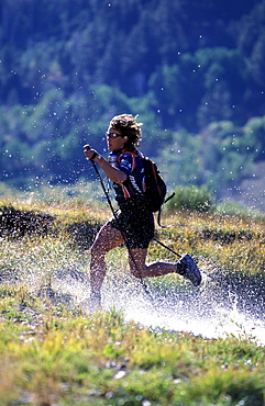 Member of Team Montrail (Rebecca Rusch) trains for the next adventure race of the season. The team spends much time hiking, running. In the photo the athlete crosses a river near Lake Tahoe in Hope Valley, California