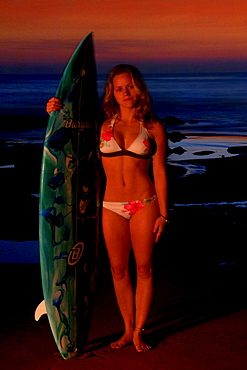 A time exposure and light painting portrait of surfer Jessica Cramp at sunset at the Golden Palm State Beach near San Pedro, California on November 5, 2005. (Photo by Lucas J. Gilman, Aurora)