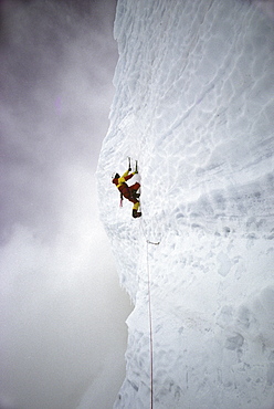 Rob Raker ascends a vertical pitch of glacial ice high on the Cassin Ridge route of Denali (Mt. McKinley), Alaska in May 1990.  This pitch is the technical crux of the route which ascends the South Face to the summit at 20,320 feet, the highest point in North America. (Photo by Kevin Steele, Aurora)