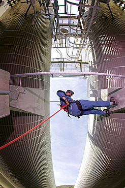 John Siekowski rappels among industrial propane tanks at a facility in Gaviota, California on March 29, 2004.  John is a member of the Santa Barbara County Search and Rescue. (Photo by Kevin Steele, Aurora)