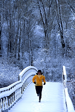 Janet Smith Running across a bridge in a snowstorm, Ridgway State Park, CO