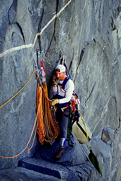 Martin Avidan takes a break to phone home from a ledge on Zodiac, a 16 pitch 5.11 A3+ route on El Capitan in Yosemite National Park, California.