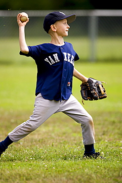 Harrison Walsh throws the ball to the third baseman during an a youth baseball game in Bolton, Ct.