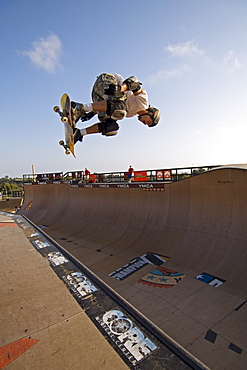 Pro skater Bob Burnquist practicing a trick on his skateboard shortly before a big competition in a skatepark in Encinitas. The skatepark was designed by legendary skateboarder Tony Hawk. California, USA.