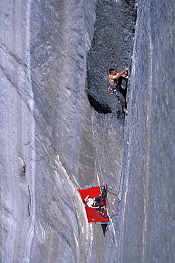 Beth Rodden belays her husband, big wall climber Tommy Caldwell, from a portalege as Caldwell is rock climbing Dihedral wall, a multi pitch route on El Capitan in Yosemite National Park, California.