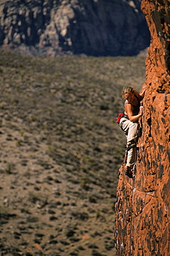 Rock climber ascends The Runaway, 5.10b. Wall of Confusion, Red Rocks, Nevada, USA