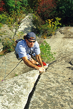 Male rock climber at Cathedral Ledge, New Hampshire.