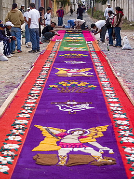 As part of the observance of Lent in Guatemala, a group of people prepares an aromatic carpet for a procession in Antigua, Guate