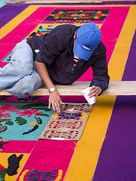 As part of the observance of Lent in Guatemala, a person prepares an aromatic carpet for a procession in Antigua, Guatemala.