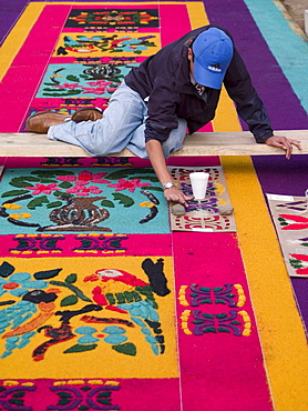 As part of the observance of Lent in Guatemala, a person prepares an aromatic carpet for a procession in Antigua, Guatemala.