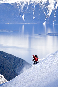 Telemark skier descends steep mountain in backcountry of southeast Alaska.