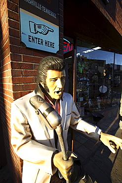 A statue of Elvis Presley on the sidewalk along Lower Broadway in Nashville, TN