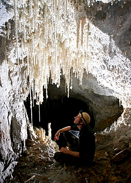 A cave explorer admires pretty cave formations in Mulu National Park.