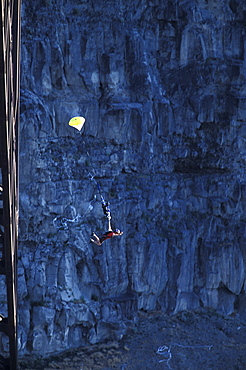 A BASE jumper opens his parachute after jumping off of a bridge in Twin Falls, Idaho.