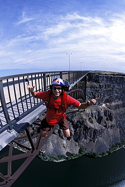 A BASE jumper smiling at the camera as he jumps off of a bridge in Twin Falls, Idaho.