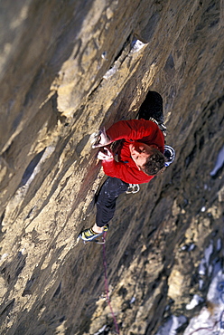 Man in a red shirt lead climbing near Rifle, Colorado (High Angle Perspective).