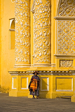 A woman in front of the church La Merced, Antigua, Guatemala