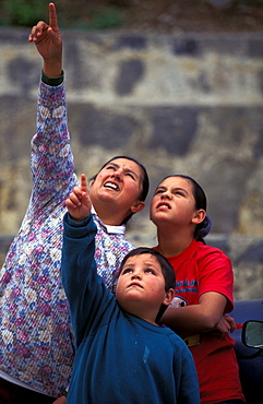 Local villagers look up and point as they watch climbers at El Potrero Chico, Mexico.