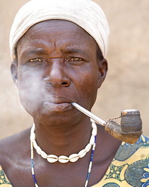 Wife of the local chief smokes a pipe