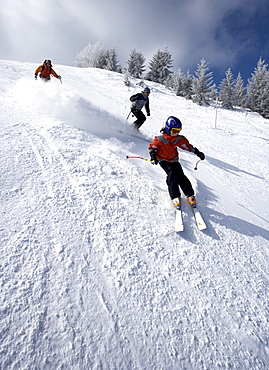 Three people skiing in France.