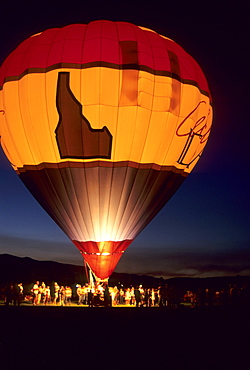 A crowd of people surround a hot air balloon at night in Salmon, Idaho.