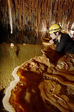 Cave explorer admires pretty Gour Pool at the most remote part of the system in Whiterock (Cave).