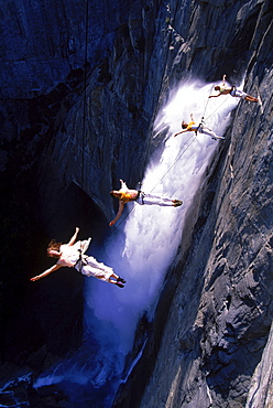 Suspended from wires 2,500 vertical feet up a cliffside in Yosemite National Park, the Bandaloop Troupe performs an air dance next to Yosemite Falls.