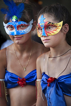 A couple of girls wearing masks during the traditional carnaval in Colonia del Sacramento, Uruguay.