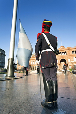 A soldier stands in front of the argentine flag during an everyday ceremony in front of the pink house (presidencial building) in Buenos Aires, Argentina.