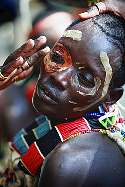 The Bull Jumping Ceremony is conducted by several tribes in the Lower Omo Valley and is the most important ceremony in a tribal man's life.The ceremony is about hierarchy and membership in the tribe and typically involves a young man who undergoes a number of rituals before he leaps onto and runs rapidly over a series of cattle held by other men who have recently bull-jumped. Once the jumping is completed, the bull-jumper is a man in the eyes of the tribe.  An important part of the ceremony is a ritualistic whipping, which women actively seek out from certain men known as Mazha. Dimeka, Omo Valley, Ethiopia, 2010