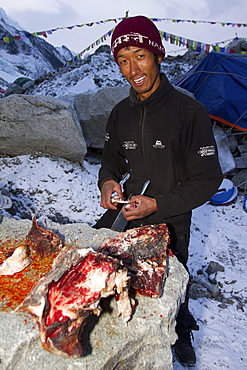 The cook for Jagged Globe Everest Expedition prepares Yak meat at Everest Base Camp