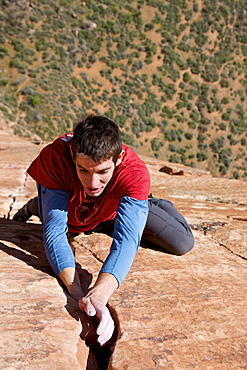 A man rock climbing in Zion National Park, UT.