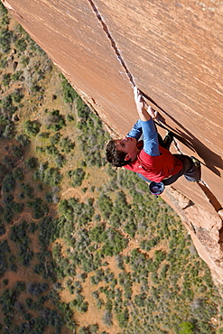 A man rock climbing in Zion National Park, UT.