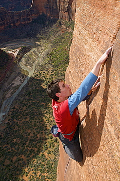 A man rock climbing in Zion National Park, UT.